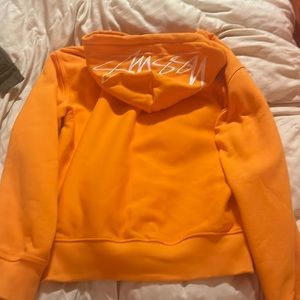 Stussy orange hoodie back hood says stussy